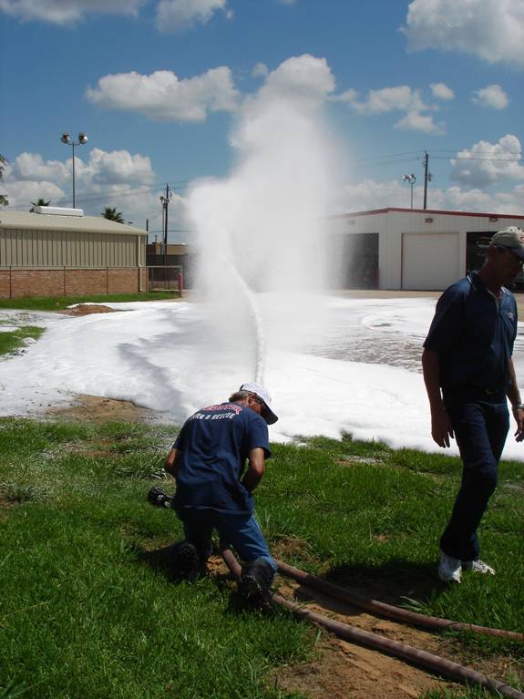 Fire fighters spraying fire hose