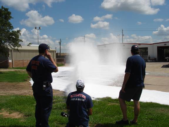 Fire fighters spraying fire hoses