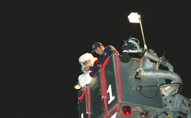 Santa Claus with officer in fire truck